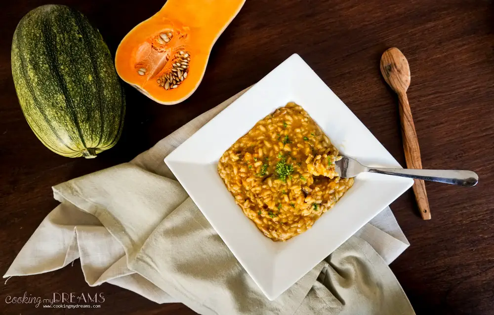 fork taking some pumpkin risotto from the plate