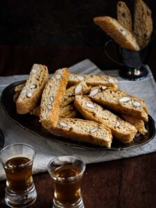 tray of cantucci with 2 shots of vin santo