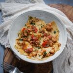 bowl of pasta with fish and tomatoes
