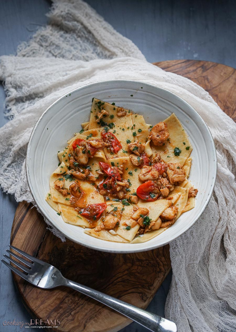 bowl of pasta with fish and tomatoes