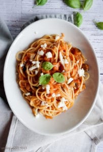 plate of spaghetti with tomato sauce and mozzarella