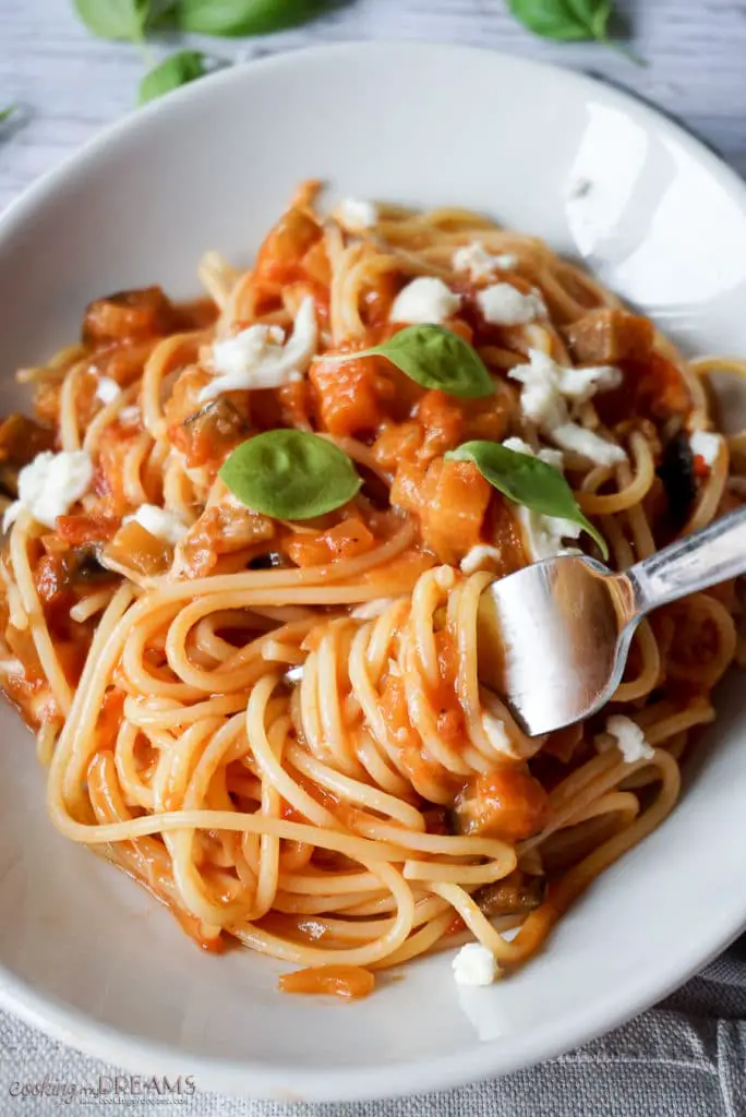 plate and fork with spaghetti with tomato sauce