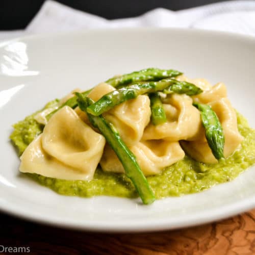 cheese cappelletti with asparagus on a plate