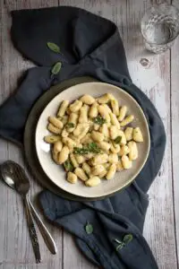 overhead plate of potato gnocchi with butter and sage