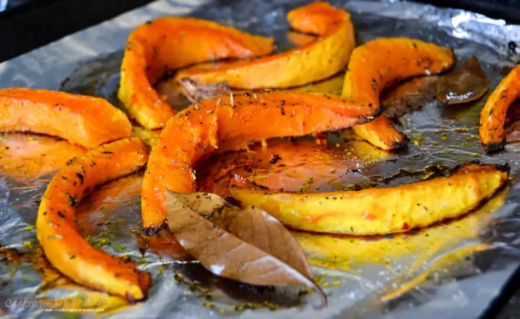 roasted pumpkin wedges on a baking tray