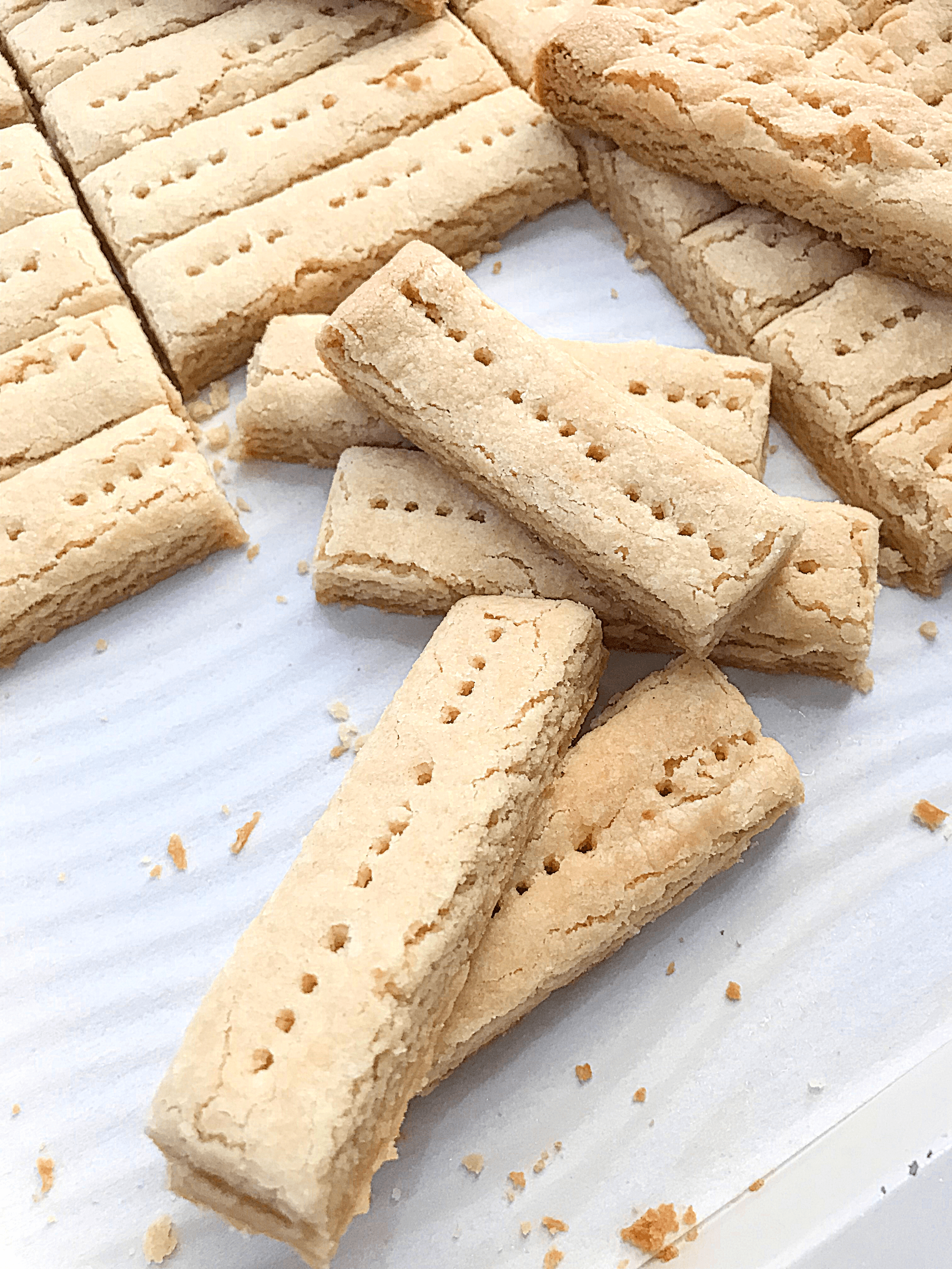 Shortbread cookies being cut on a sheet