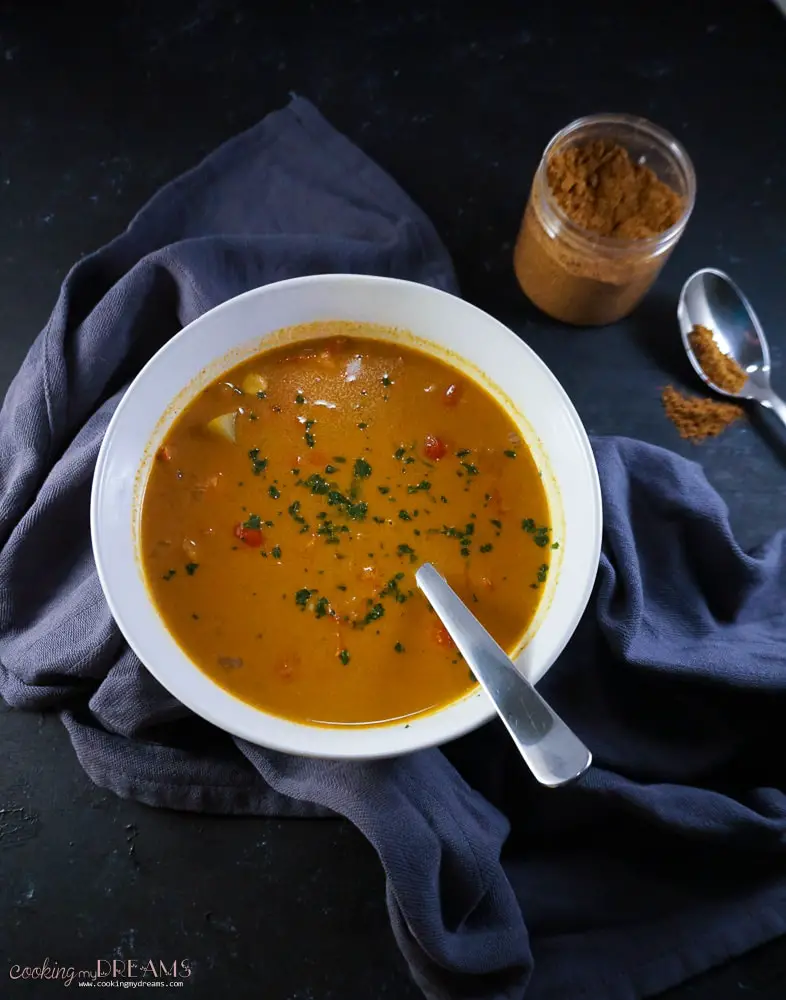 Overhead bowl of vegetable soup with garam masala spices