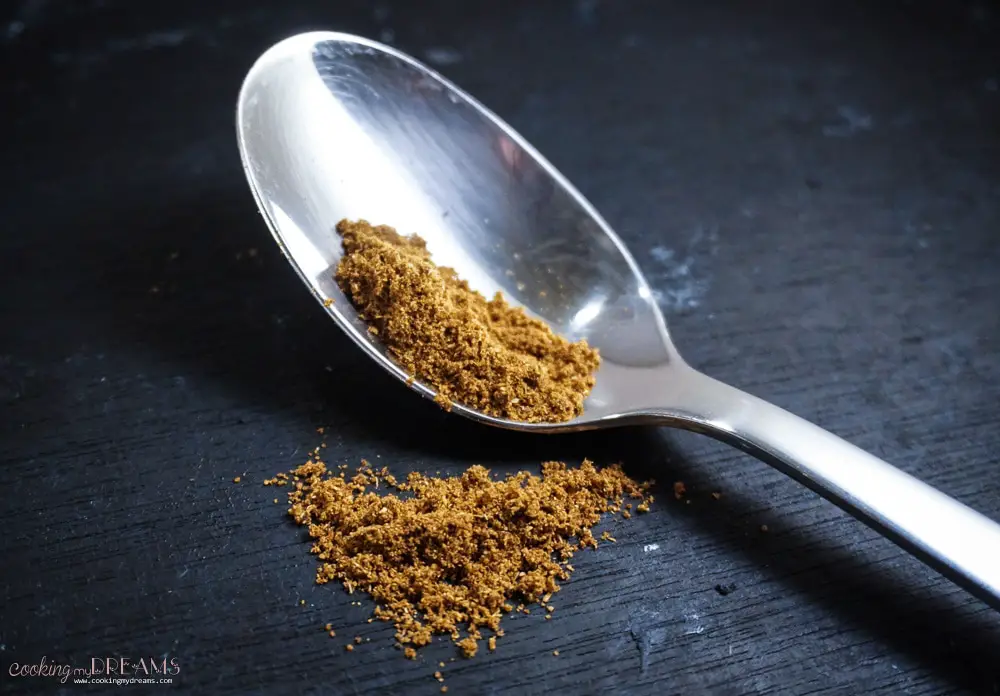 Spoon on table with Garam Masala spice powder