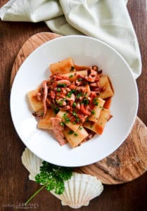calamarata pasta with squids and tomato sauce
