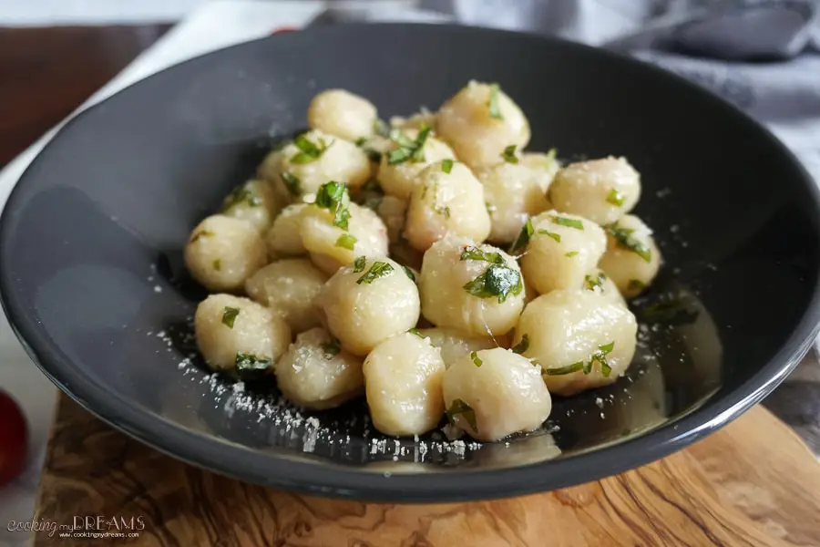 photo of black plate with potato gnocchi