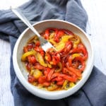 marinated roasted bell peppers in a white bowl