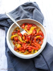 marinated roasted bell peppers in a white bowl
