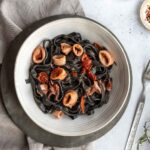 overhead plate with squid ink tagliatelle with squid sauce