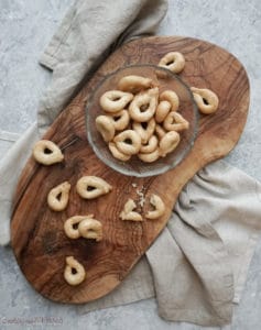 cutting board with tarallini and a little bowl