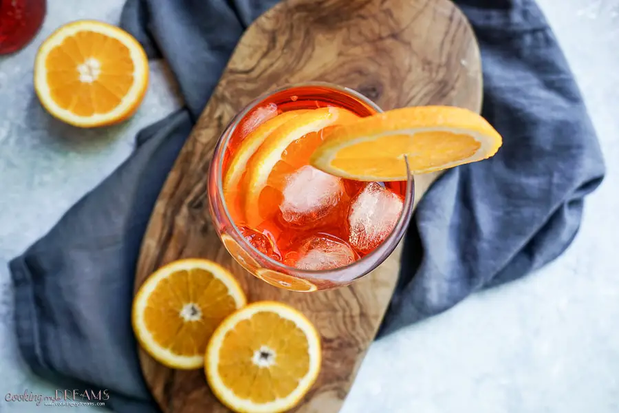overhead of a glass of spritz with ice and orange slices