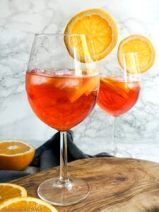 2 glasses of aperol spritz with orange slices