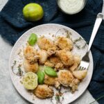 overhead plate of calamari with lime and bowl of mayo