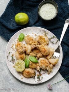 overhead plate of calamari with lime and bowl of mayo