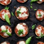 cooked eggplant pizzas on a baking tray