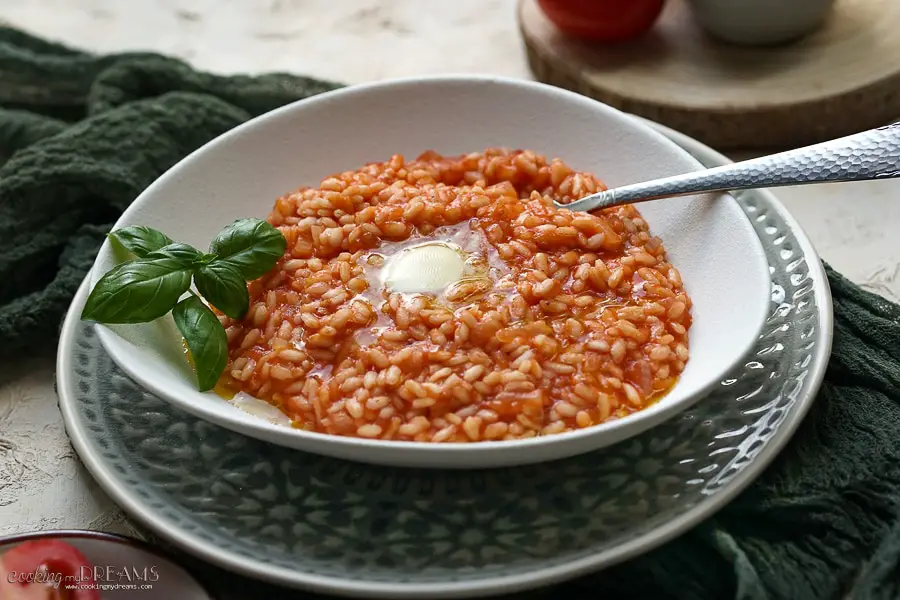risotto with basil, a slice of butter and a fork