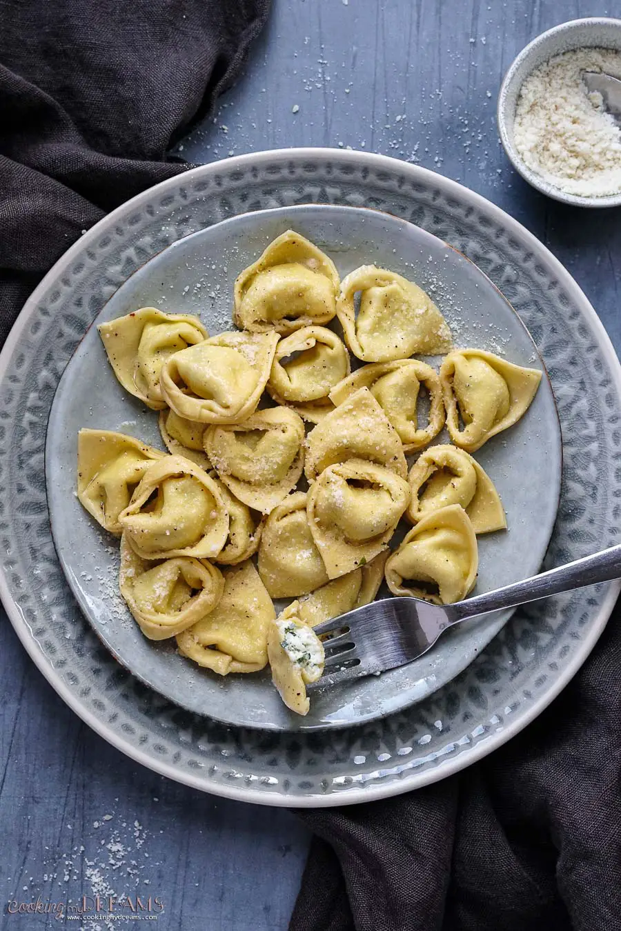 plate of tortelli with fork holding half