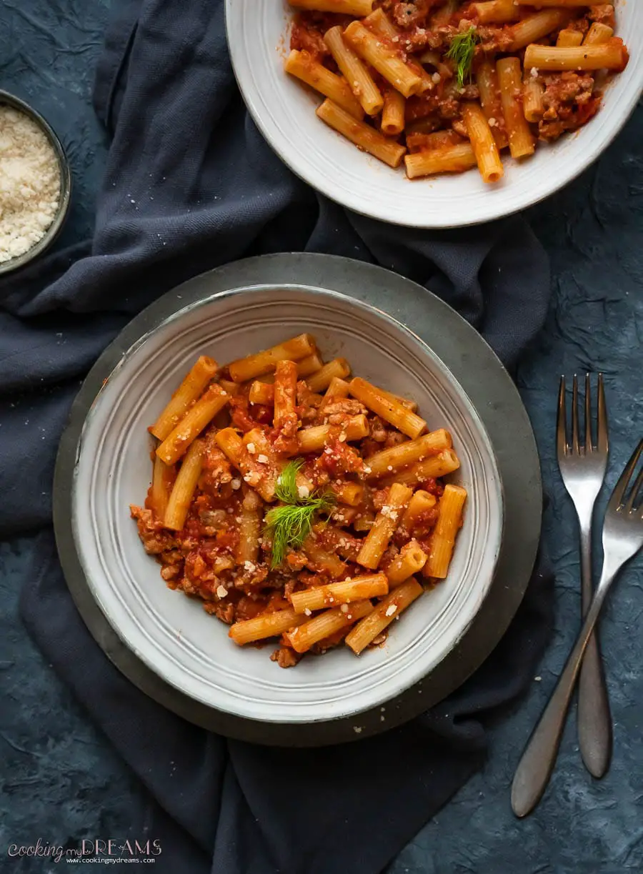 overhead dish with pasta and sausage tomato sauce