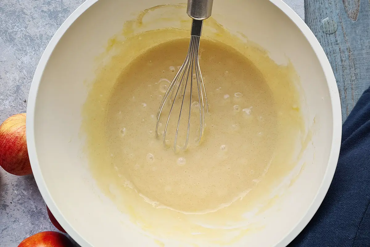 whisk mixing all ingredients in a bowl.