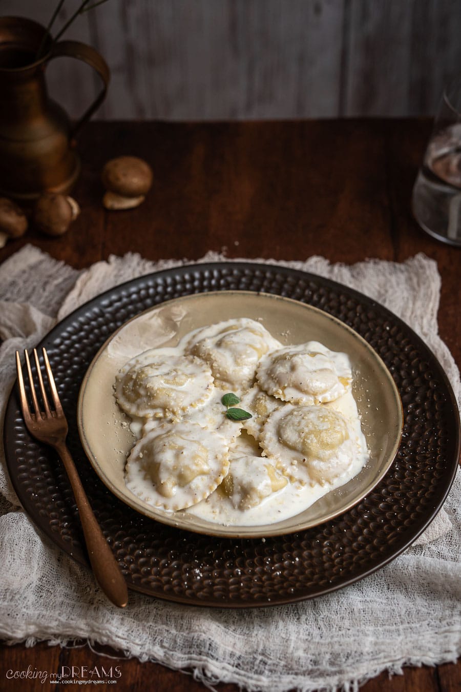 plate with wild mushroom ravioli in parmigiano cream sauce
