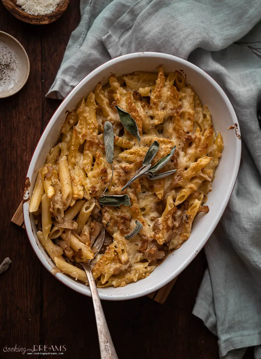 overhead dish with baked caramelized onion pasta bake with a spoon