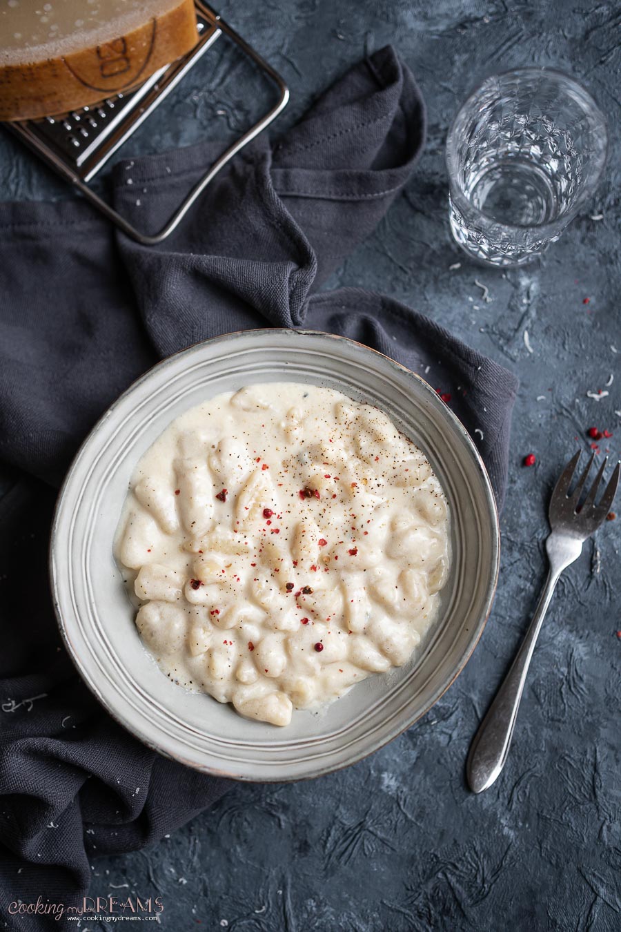 overhead grey bowl with potato gnocchi with four cheese sauce 