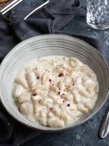 grey bowl with potato gnocchi with four cheese sauce