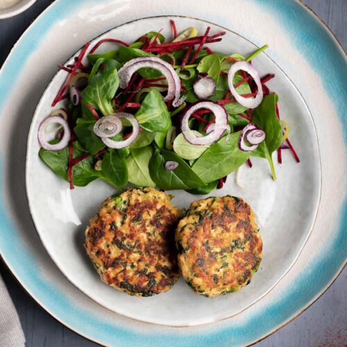 overhead of plate with two salmon cakes and a salad