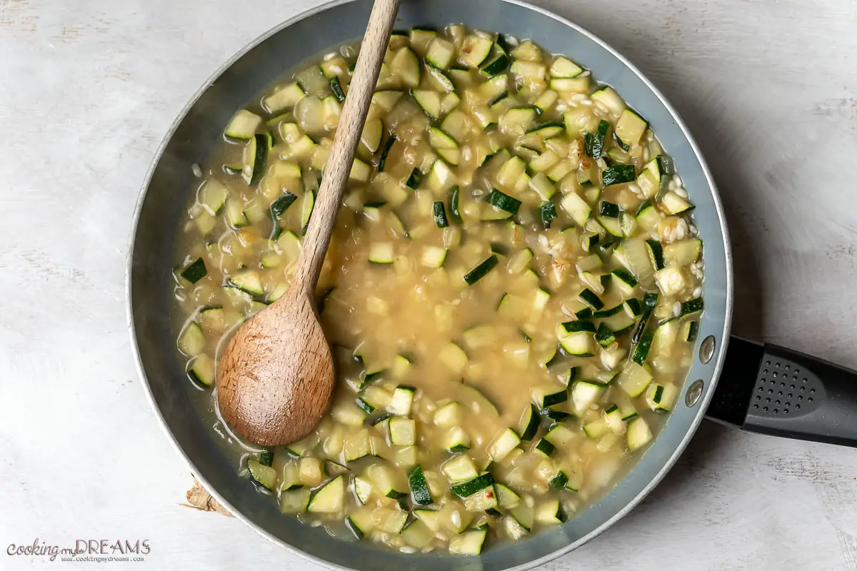 vegetable stock is added to the risotto pan