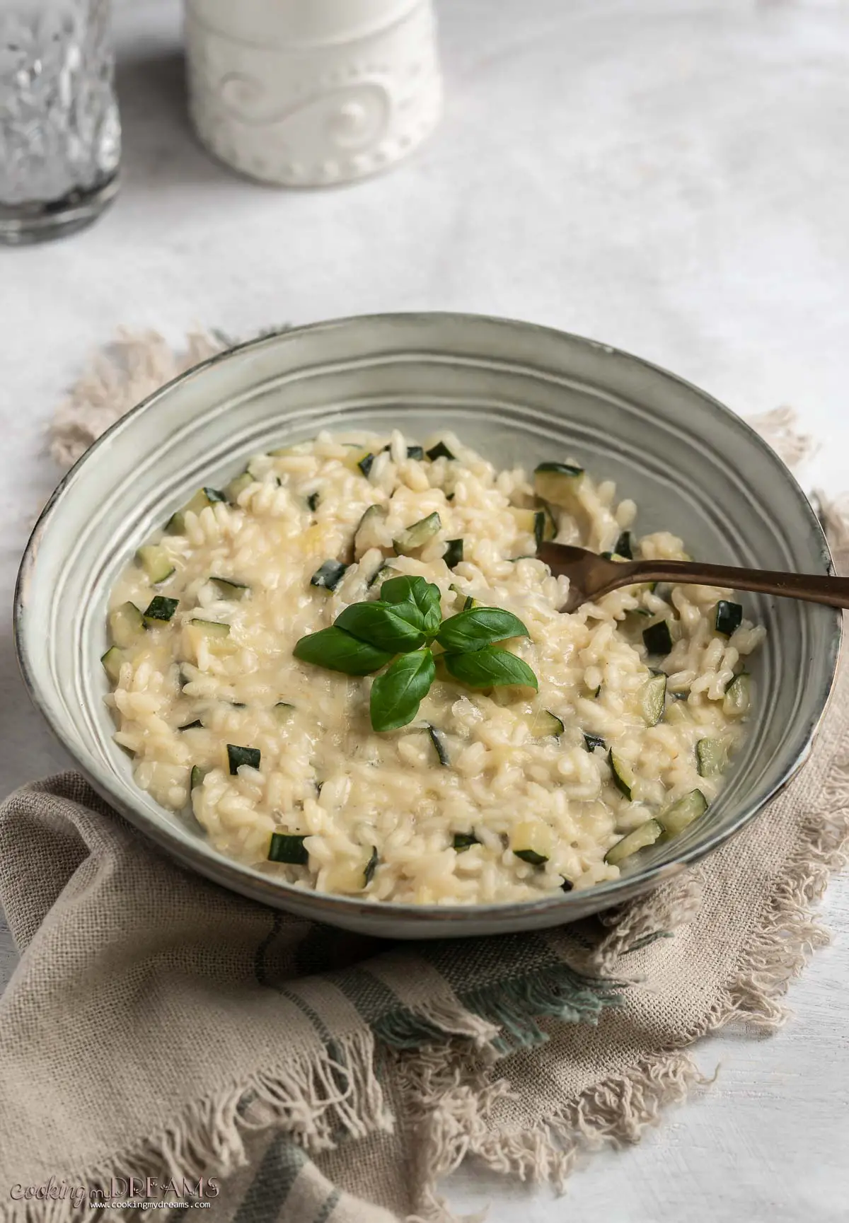 bowl of parmesan zucchini risotto with a fork