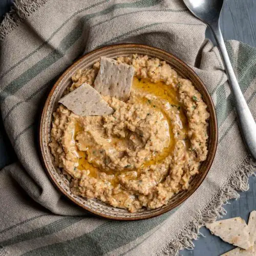 sriracha chickpea dip in a bowl with crackers