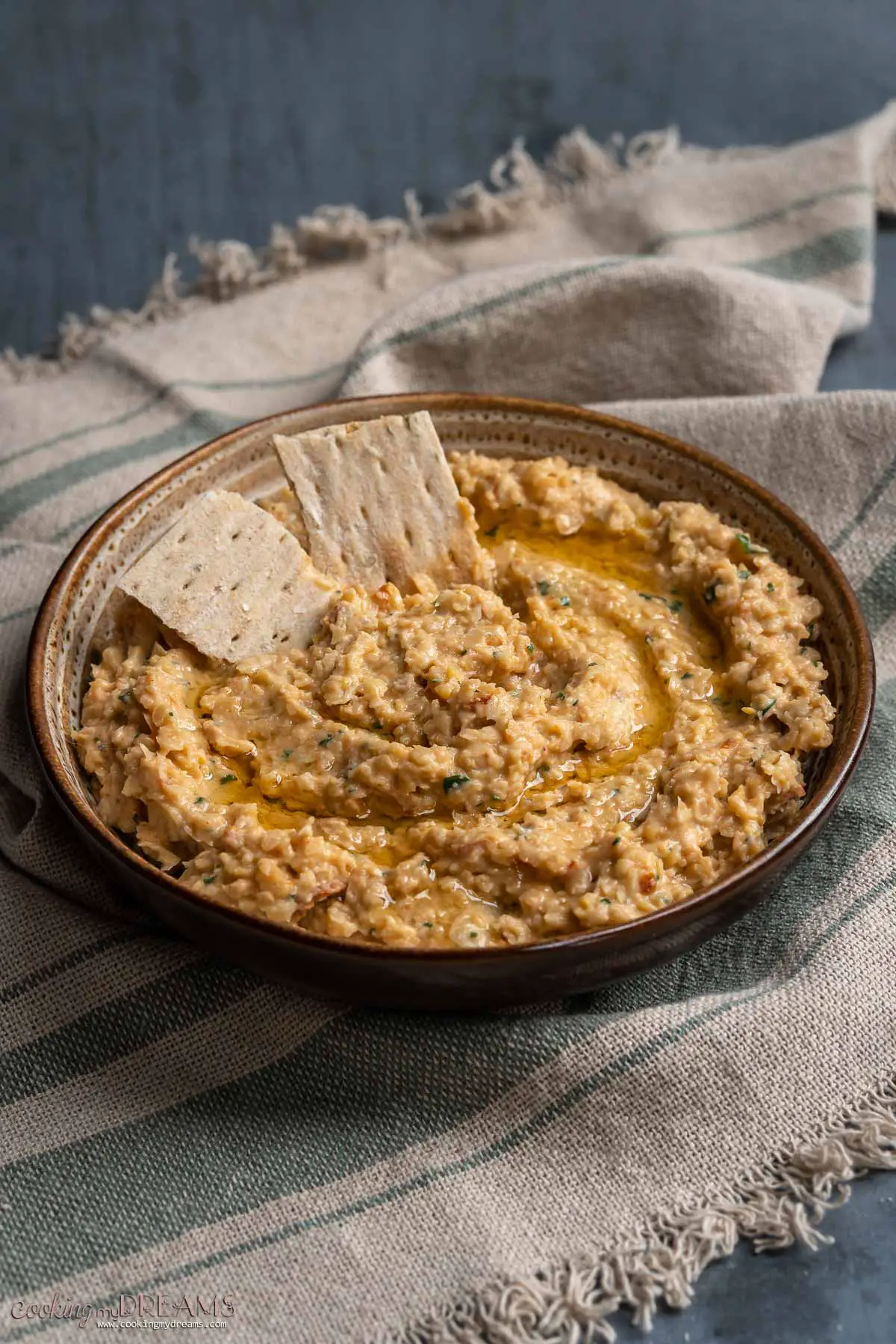 sriracha chickpea dip in a bowl with crackers
