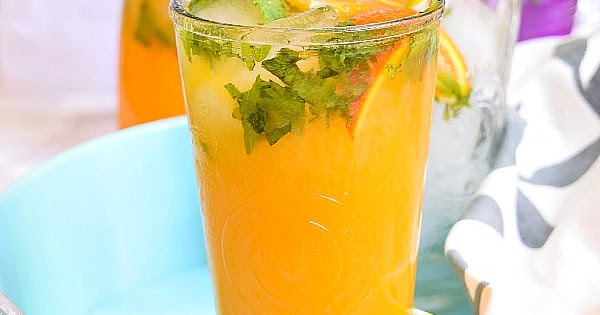 glass of orange mojito with mint