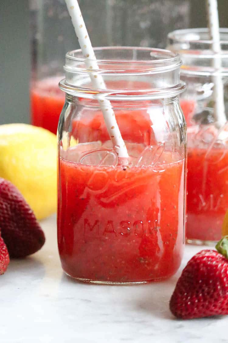 jar with strawberry chia lemonade with a straw