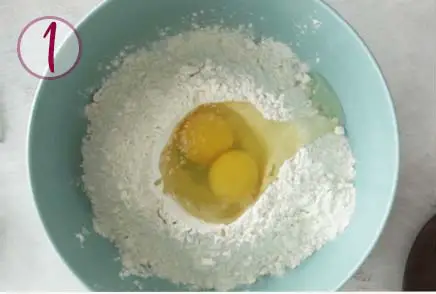 eggs and flour in a blue bowl
