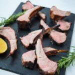 bbq lamb chops on a board with rosemary