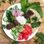 platter of lamb kebabs and vegetables