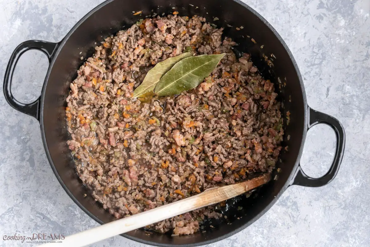 minced meat and spices are added to the pot