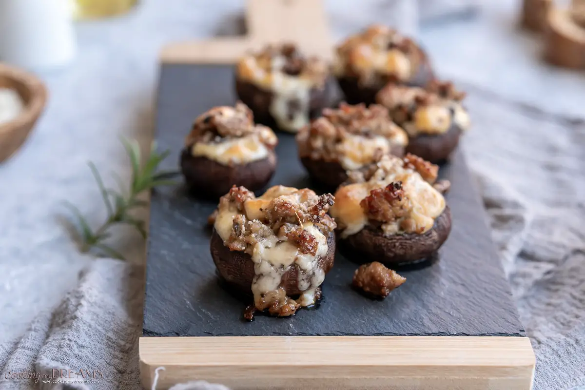 sausage and cheese stuffed champignons on a tray