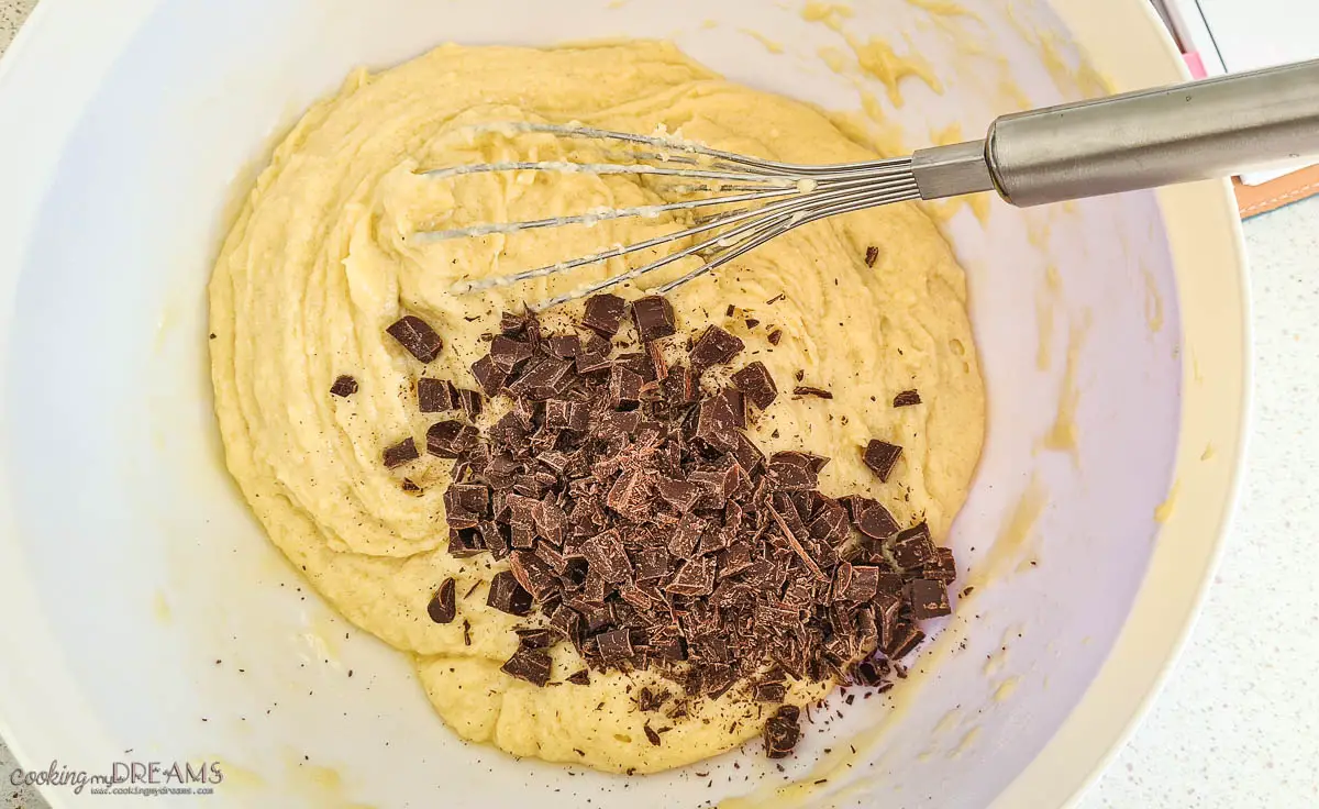 chocolate chunks are added into the bowl with cake dough