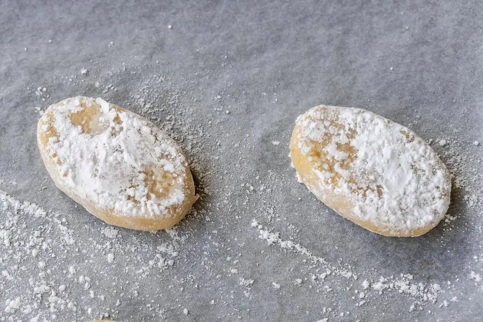 ricciarelli placed on a baking sheet and dusted with sugar