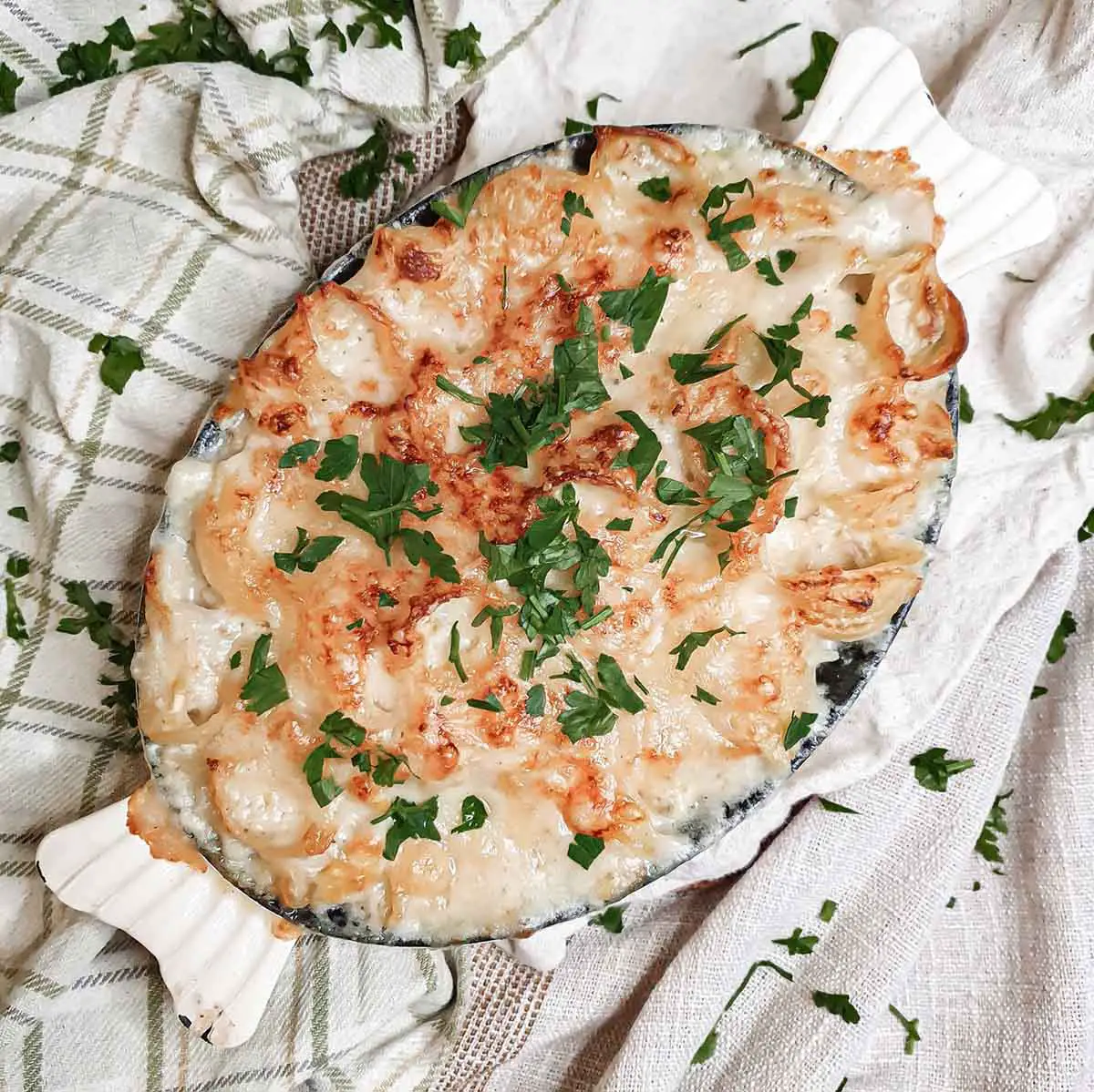 baking dish with smoked haddock baked pasta topped with parsley