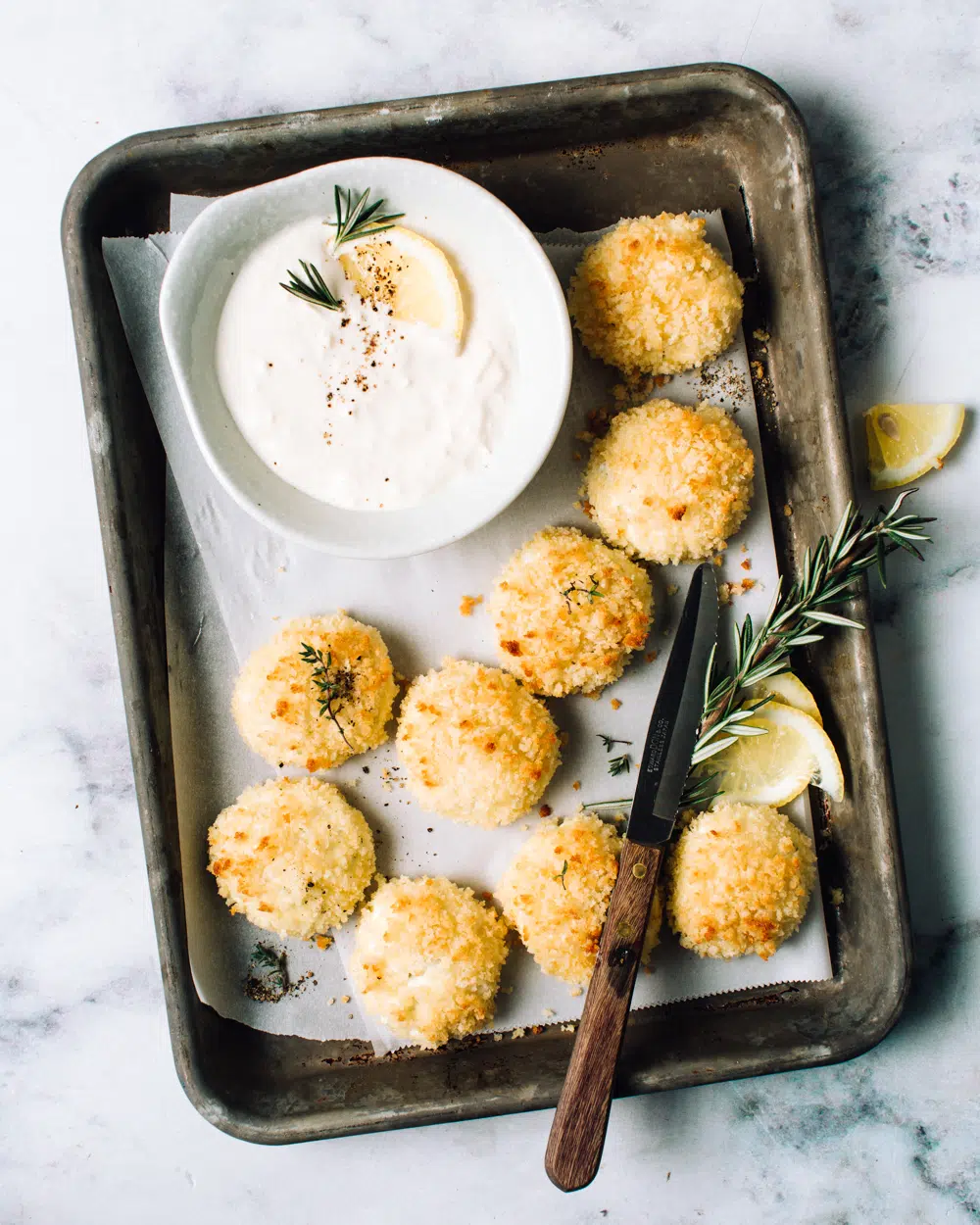 baked cheese fritters on a baking tray