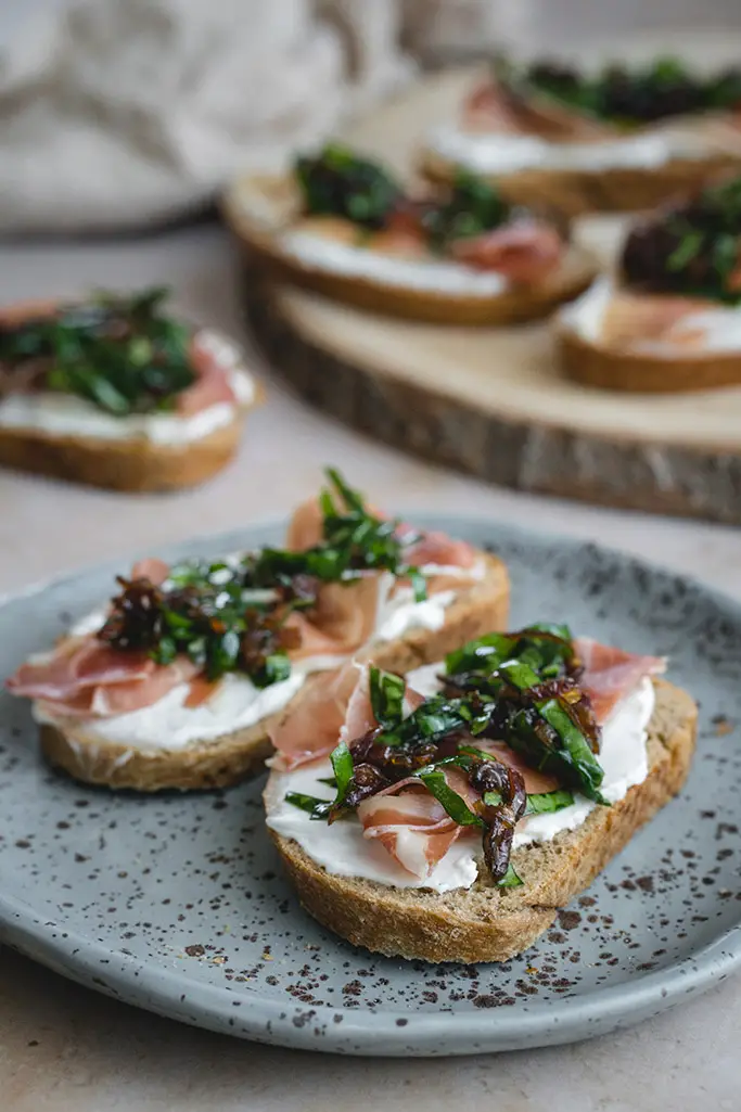 two crostini slices on a grey plate