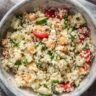 closeup of couscous with tomatoes, cucumber, chickpeas and herbs