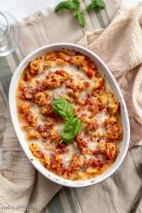 oval baking dish with tomato cheese baked tortellini
